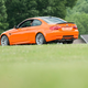 The back end of an orange BMW M3